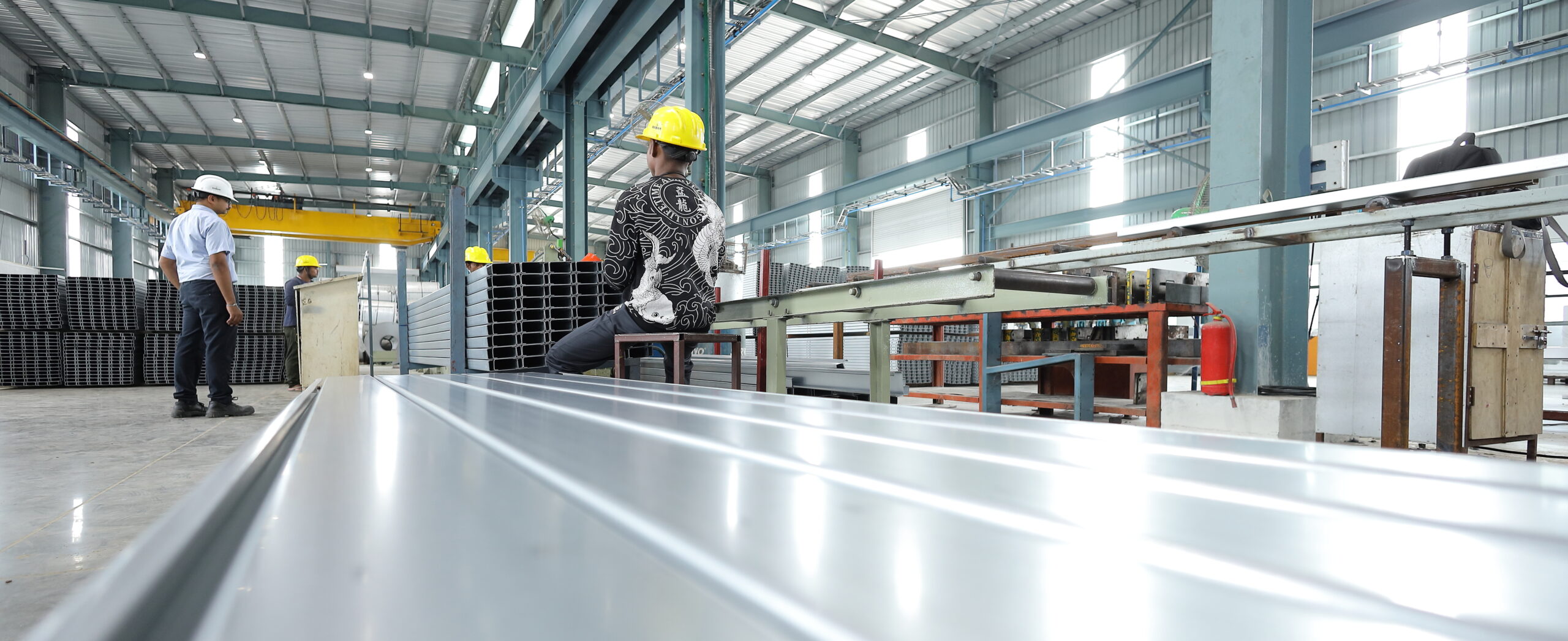 Wide angle industrial factory interior with production workspace and machinery