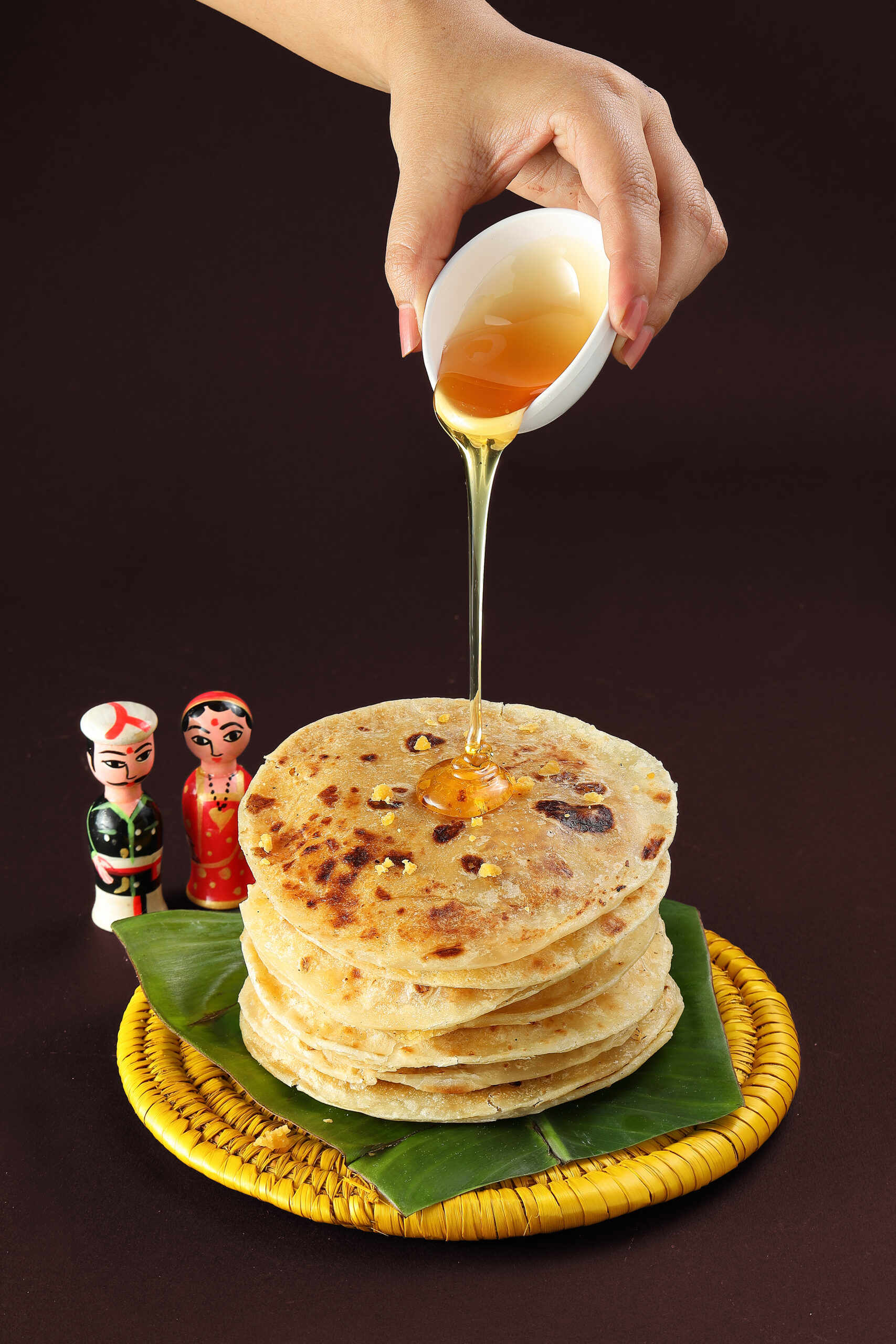 Pancake dessert food photography with honey drizzle and dramatic studio lighting